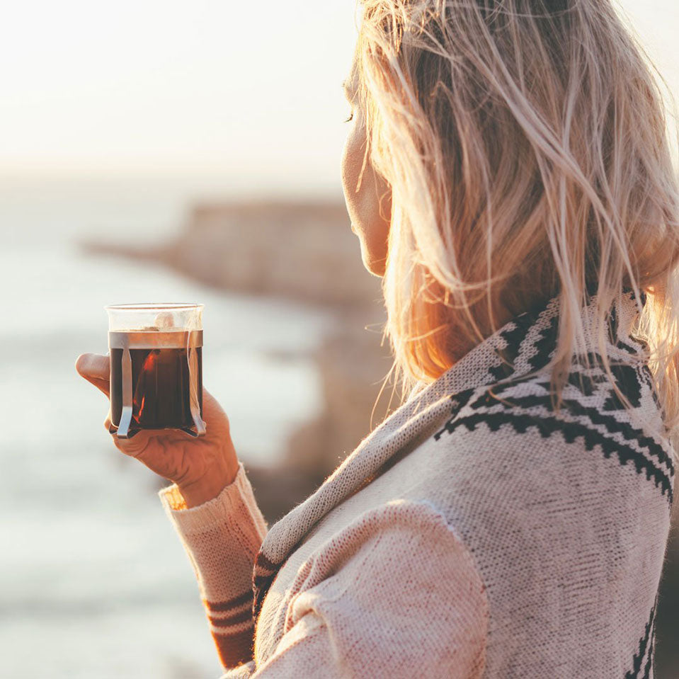 woman drinking bone broth powder outdoors