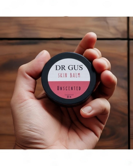 a man holding a pot of DR GUS tallow skin balm