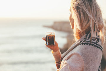 woman drinking a mug of dr gus bone broth powder